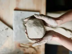 Hands molding clay