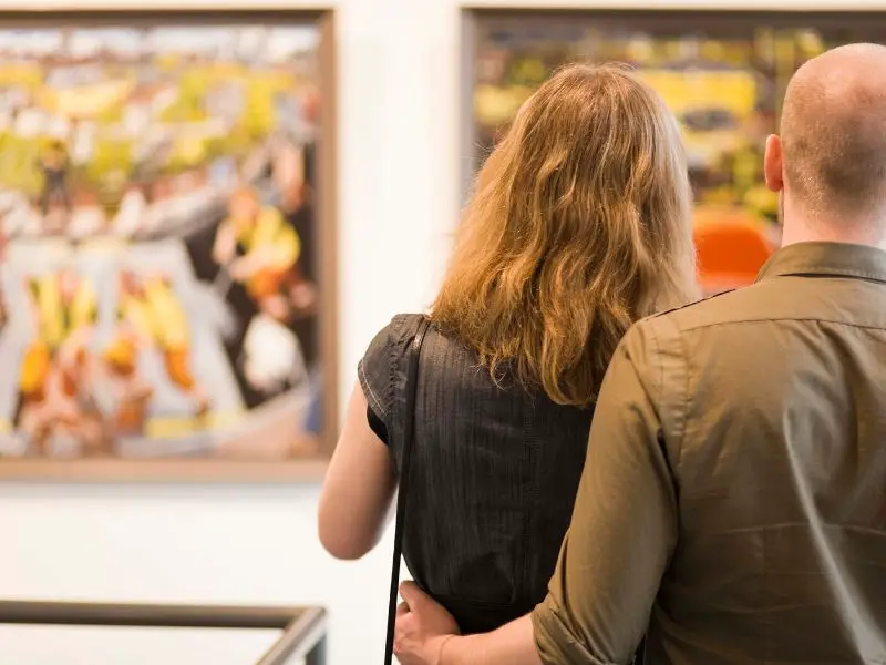 Couple admiring pictures at a museum