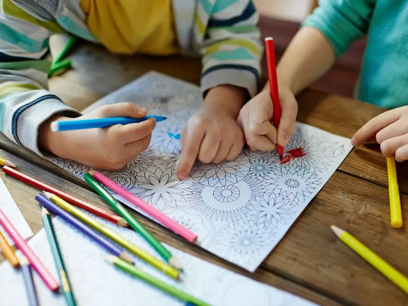 Kids coloring a mandala image