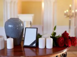 Urn set up with candles and roses on a table